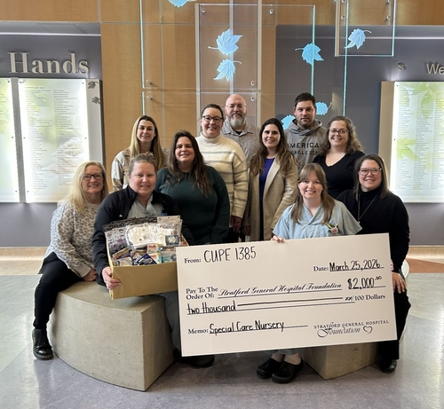 Members of CUPE 1385 pose with hospital and foundation representatives in the June Blanch Lobby holding an oversized cheque for $2,000 supporting the Special Care Nursery